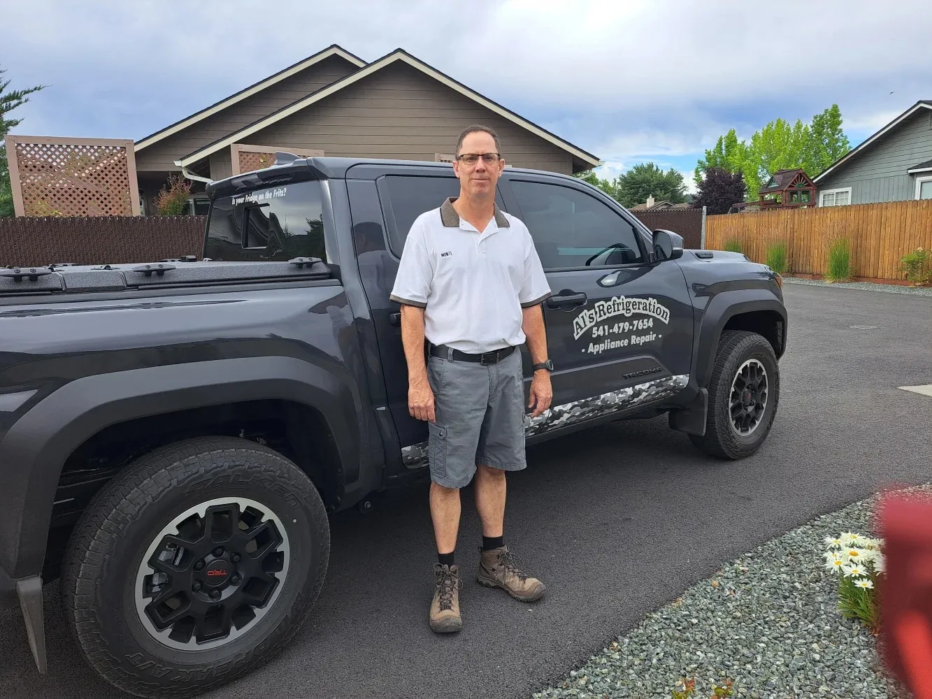 Monte beside his AL's Refrigeration Tacoma