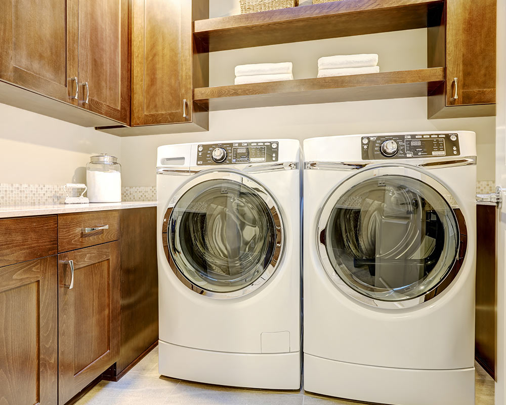 small laundry room with wooden cabinets and washer and dryer grants pass o